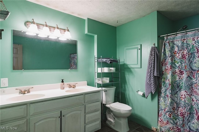 full bath with a textured ceiling, tile patterned flooring, a sink, and toilet