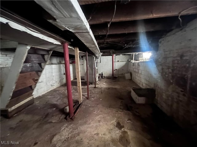 unfinished basement featuring heating unit