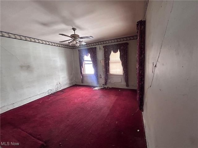 carpeted empty room featuring ceiling fan