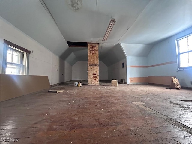 additional living space featuring lofted ceiling