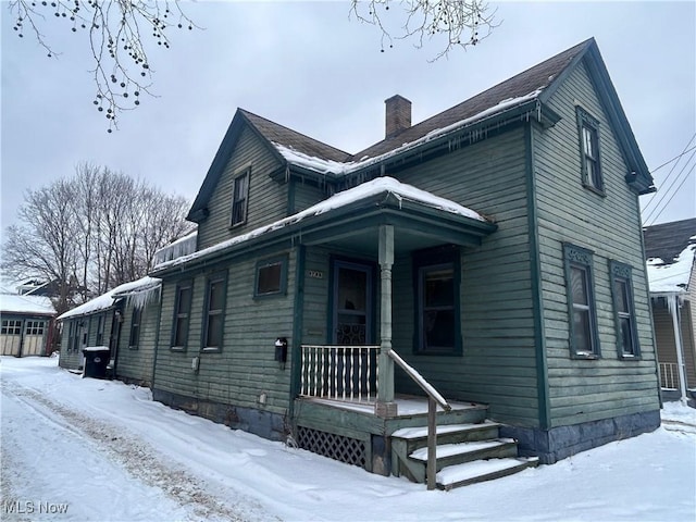 view of front of property with a porch and a chimney