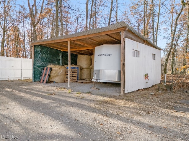 view of outbuilding with an outbuilding and fence