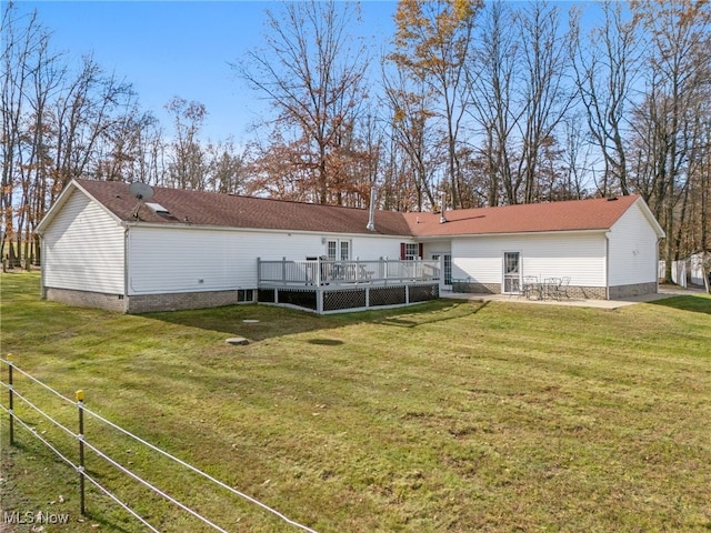 exterior space featuring a deck and a front lawn