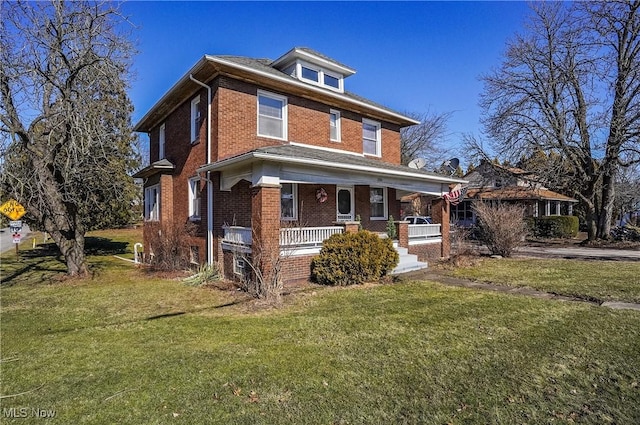 traditional style home with covered porch, brick siding, and a front lawn