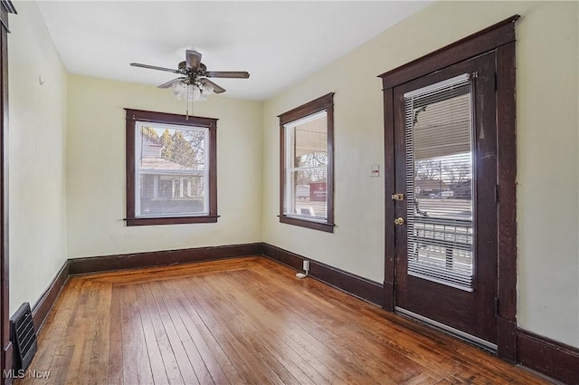 foyer featuring a ceiling fan, baseboards, visible vents, and hardwood / wood-style floors