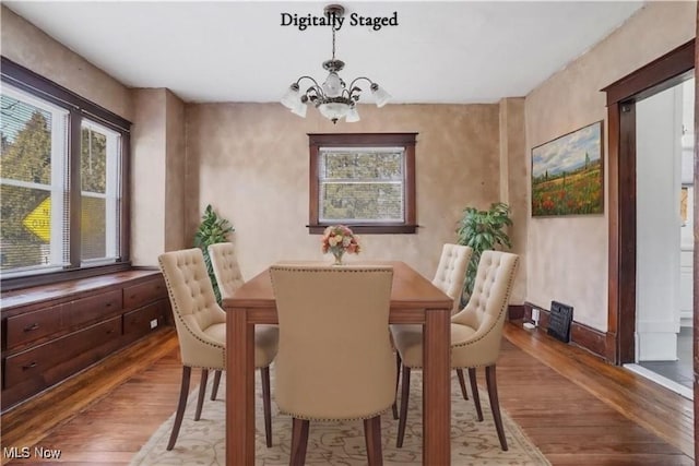 dining room featuring a chandelier and wood finished floors