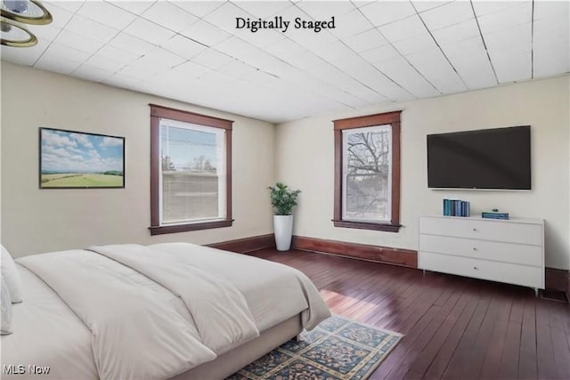 bedroom featuring wood-type flooring and baseboards