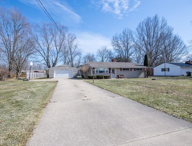 10684 Barcus Ave NE, Alliance, OH 44601 - single story home with a detached garage, fence, a front lawn, and an outbuilding