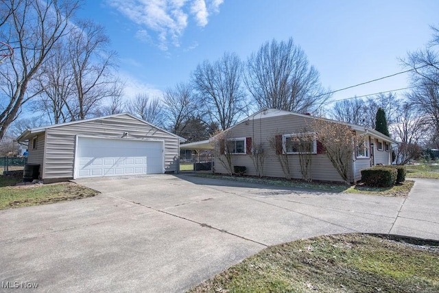 10684 Barcus Ave NE, Alliance, OH 44601 - view of home's exterior with a detached garage, cooling unit, and an outbuilding