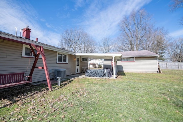 10684 Barcus Ave NE, Alliance, OH 44601 - rear view of house with central AC unit, fence, a carport, and a yard