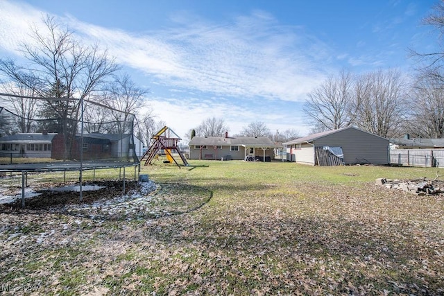 10684 Barcus Ave NE, Alliance, OH 44601 - view of yard featuring a trampoline, a playground, fence, and an outdoor structure