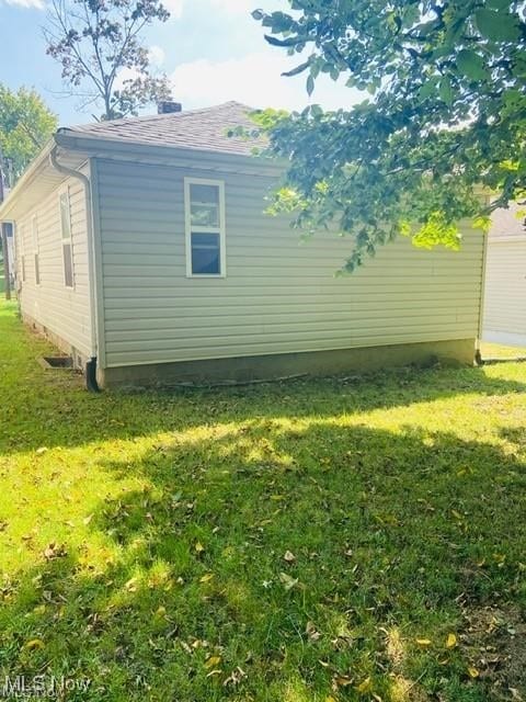 view of property exterior with a lawn