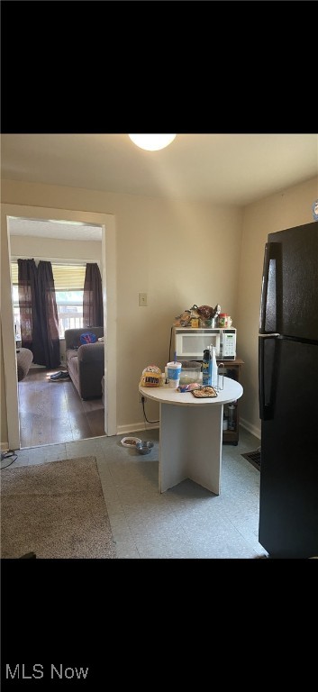 unfurnished dining area featuring baseboards