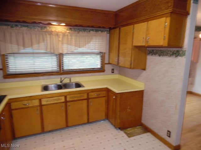 kitchen with light countertops, a sink, and light floors