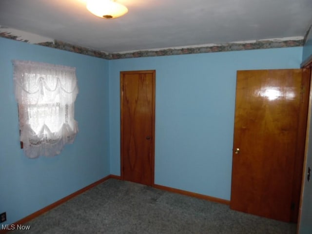 spare room with carpet flooring and baseboards