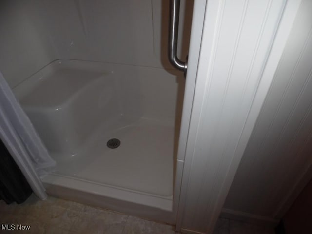 full bath with a shower stall