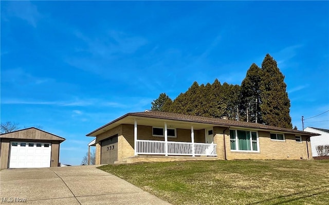 single story home with brick siding, a porch, driveway, and a front yard