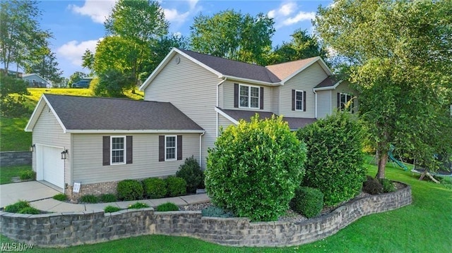 view of front of home featuring a garage, driveway, and a front lawn