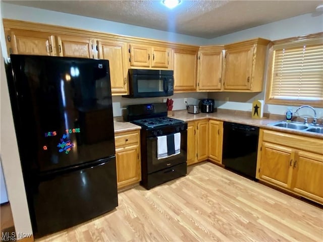 5 Grandview Dr, Mineral Wells, WV 26150 - kitchen featuring light wood-style floors, light countertops, a textured ceiling, black appliances, and a sink
