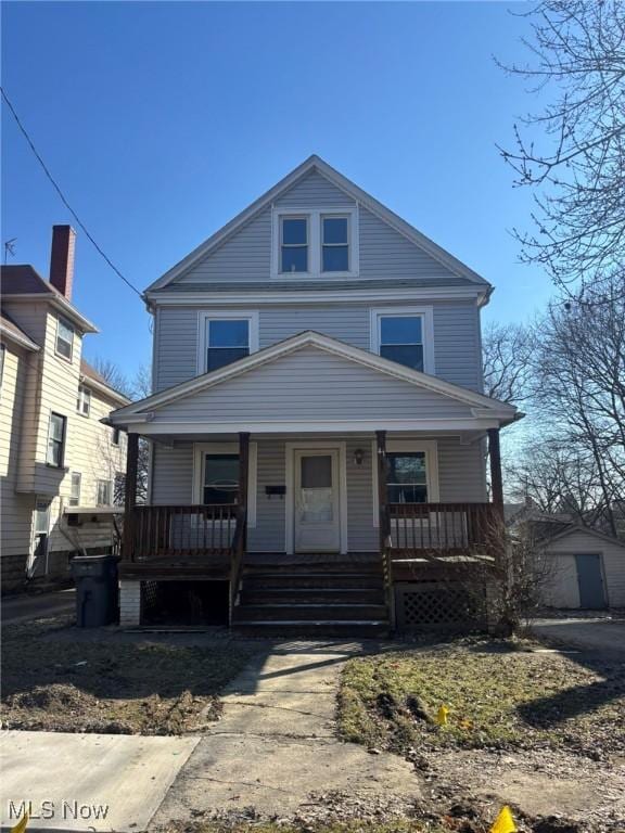 american foursquare style home featuring covered porch