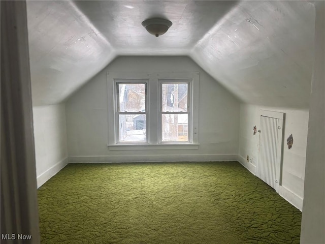 bonus room with lofted ceiling, carpet flooring, and baseboards