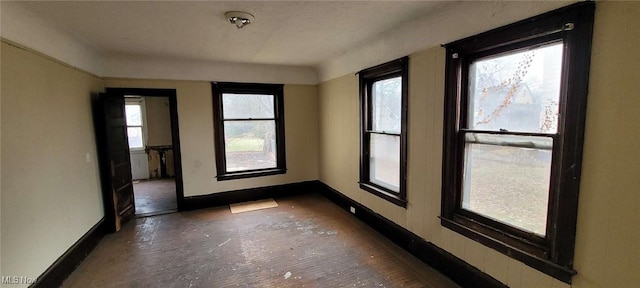 spare room featuring baseboards