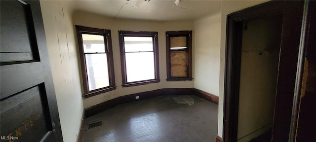 empty room featuring visible vents and baseboards