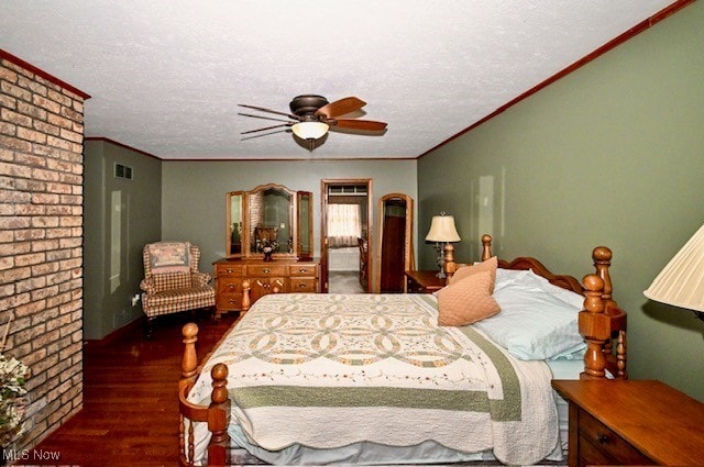 10400 Stoneacre St NW, Canal Fulton, OH 44614 - bedroom featuring wood finished floors, ornamental molding, a textured ceiling, a ceiling fan, and brick wall