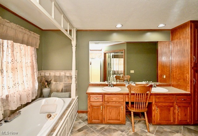 10400 Stoneacre St NW, Canal Fulton, OH 44614 - bathroom featuring a garden tub, double vanity, tile patterned flooring, recessed lighting, and baseboards