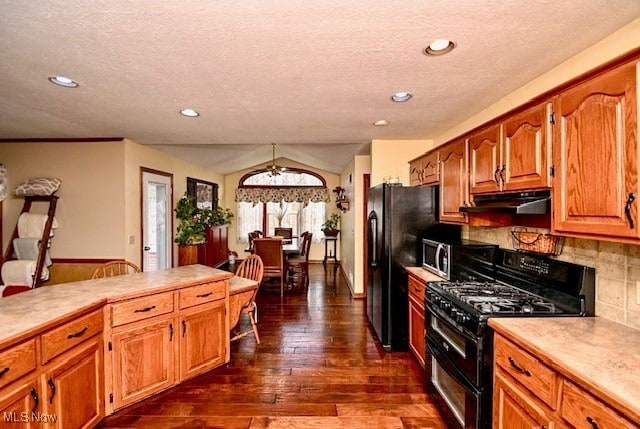 10400 Stoneacre St NW, Canal Fulton, OH 44614 - kitchen with black appliances, under cabinet range hood, light countertops, dark wood-style flooring, and a textured ceiling