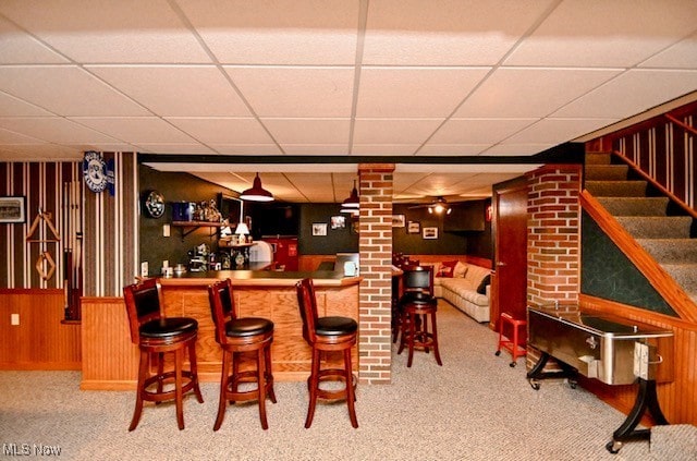 10400 Stoneacre St NW, Canal Fulton, OH 44614 - indoor dry bar with a drop ceiling, carpet, wooden walls, and stairs