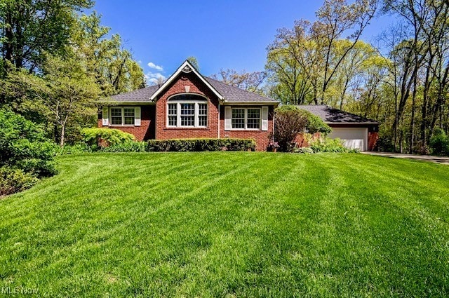 10400 Stoneacre St NW, Canal Fulton, OH 44614 - ranch-style house with a front lawn, a garage, and concrete driveway