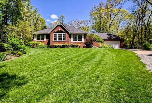 10400 Stoneacre St NW, Canal Fulton, OH 44614 - single story home with gravel driveway, a front yard, an attached garage, and brick siding