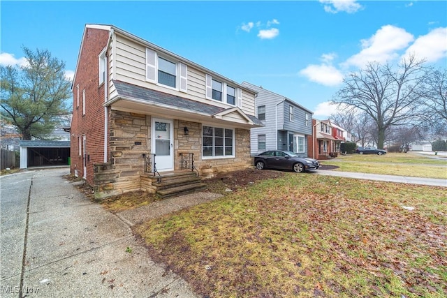 multi unit property featuring stone siding and a front lawn