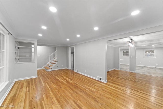 basement featuring light wood finished floors, recessed lighting, visible vents, stairway, and baseboards