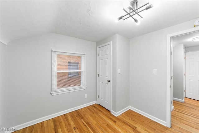 interior space featuring light wood-style flooring and baseboards