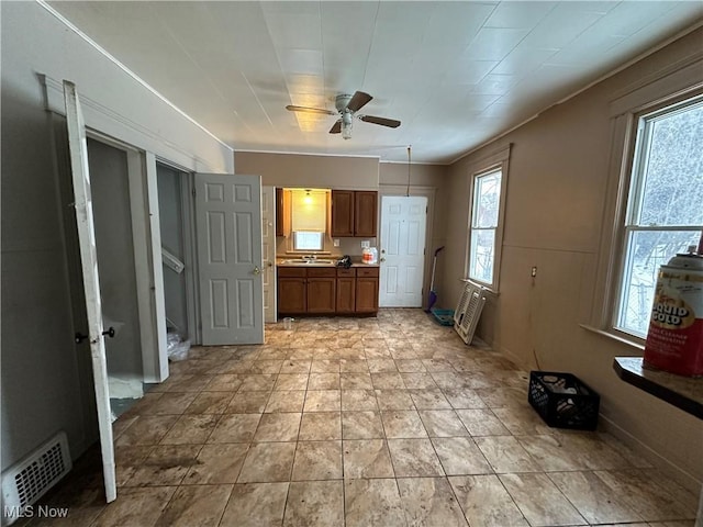 kitchen featuring brown cabinets, visible vents, a sink, and ceiling fan