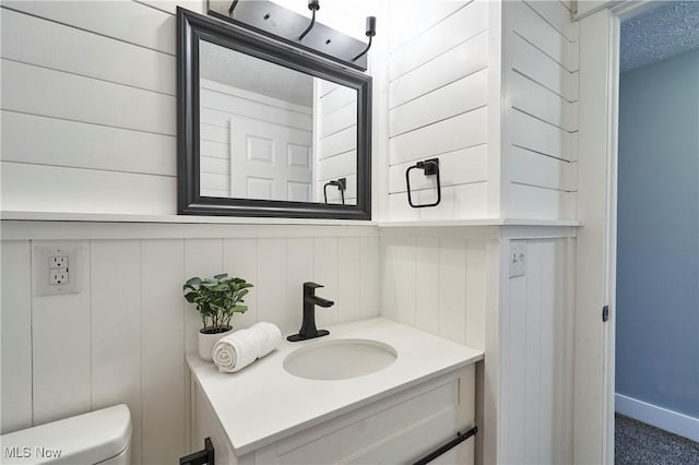 half bathroom featuring toilet and vanity