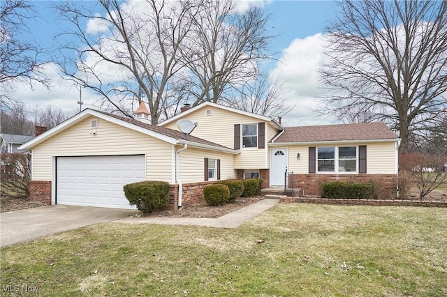 tri-level home featuring brick siding, a front lawn, and an attached garage