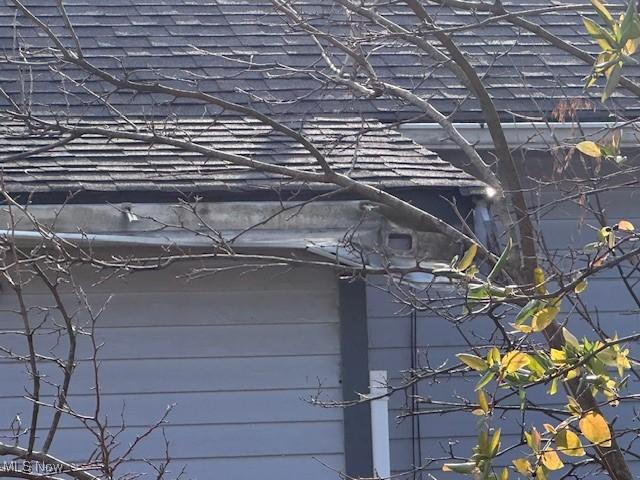 exterior details with a shingled roof