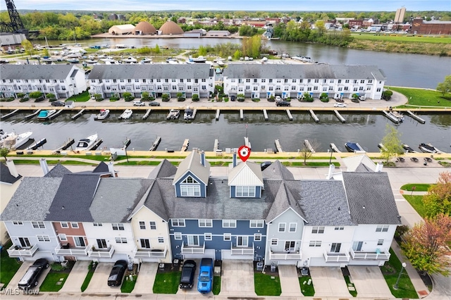 drone / aerial view with a water view and a residential view