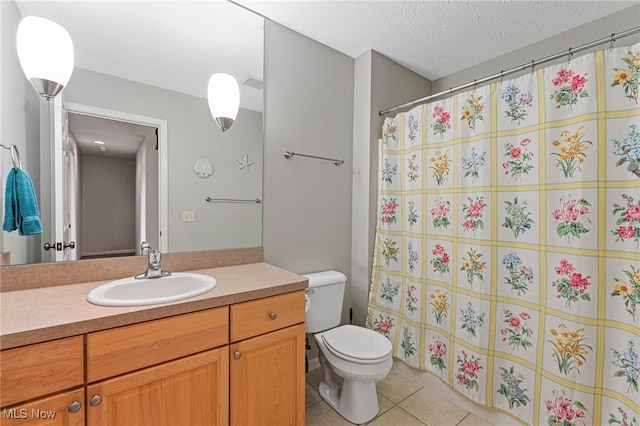 full bath featuring a textured ceiling, curtained shower, tile patterned flooring, toilet, and vanity