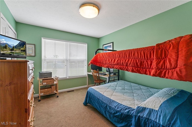 bedroom featuring carpet floors, visible vents, a textured ceiling, and baseboards