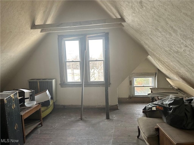 bonus room featuring lofted ceiling and a textured ceiling