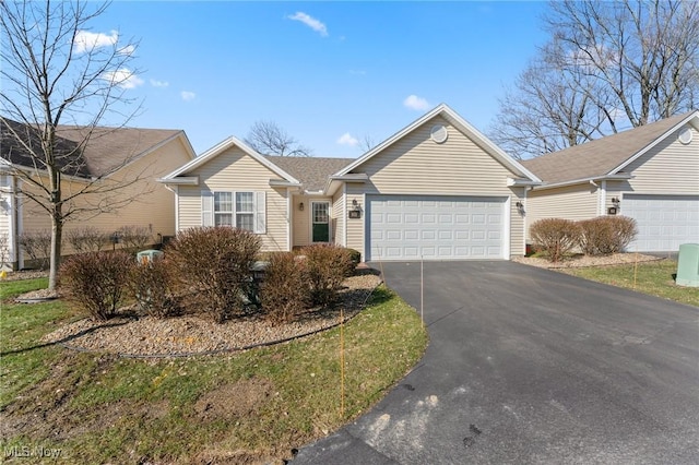 ranch-style house with aphalt driveway and a garage