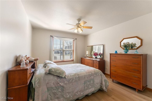 bedroom with light wood finished floors and a ceiling fan