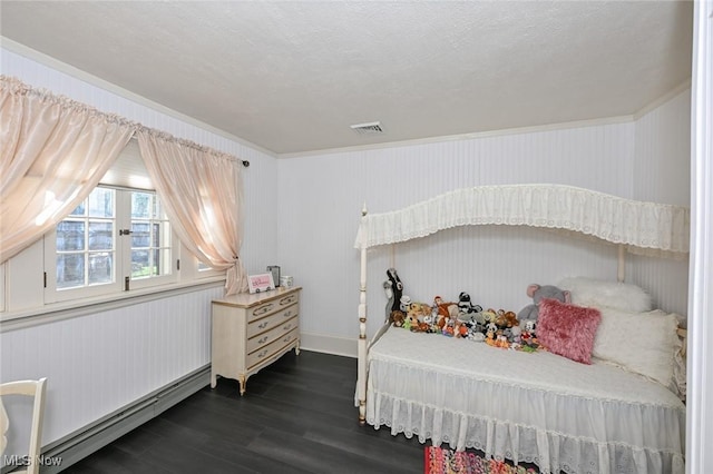 bedroom featuring dark wood-style floors, a baseboard radiator, visible vents, and a textured ceiling