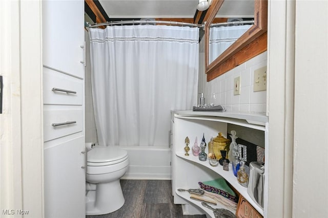 bathroom with tasteful backsplash, wood finished floors, toilet, and shower / bathtub combination with curtain