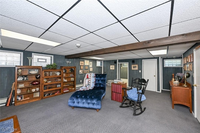 interior space with a paneled ceiling and carpet