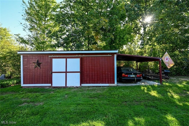 view of outbuilding featuring a carport and an outdoor structure